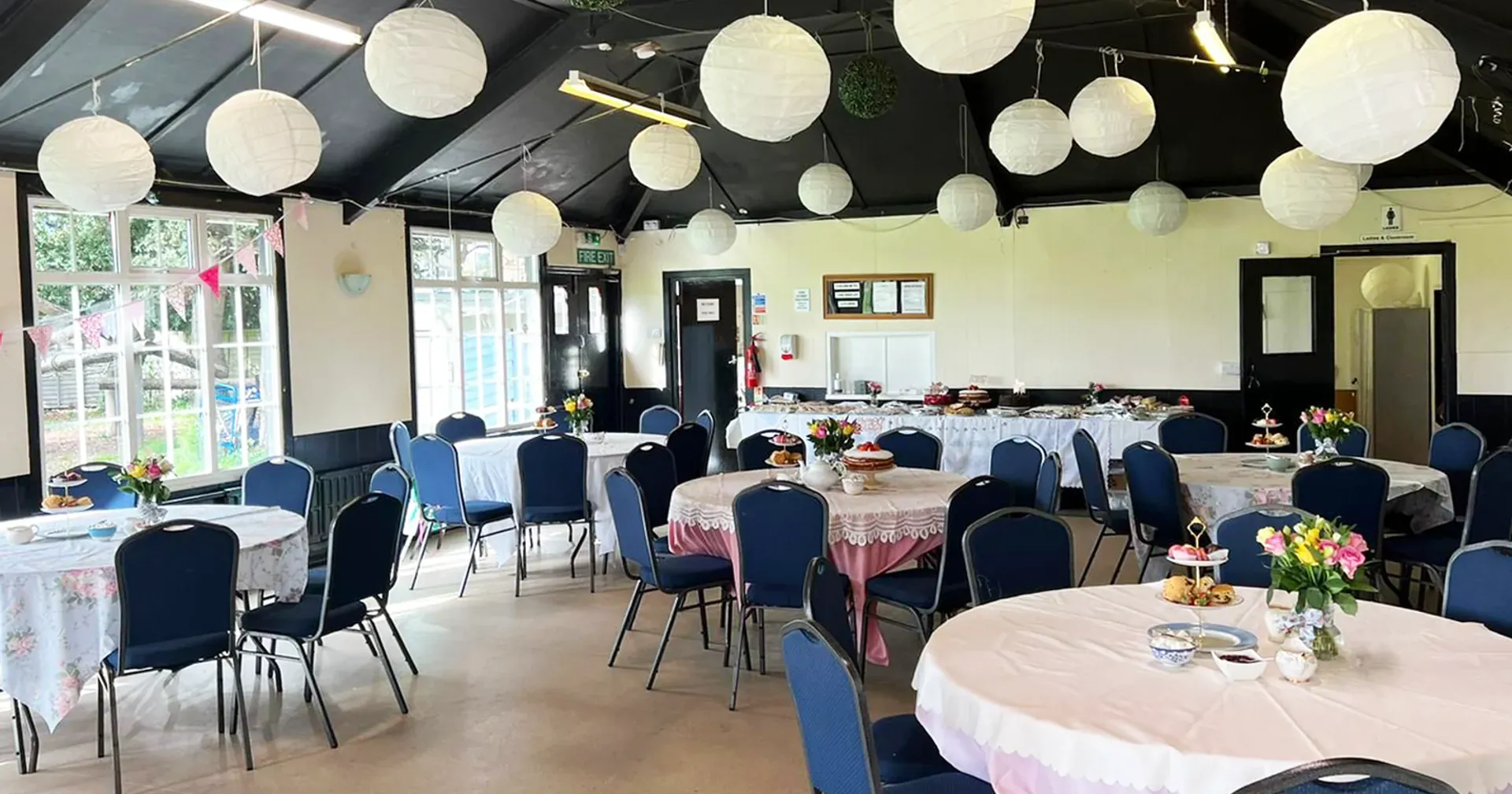 The Whitton Park Sports Association function room, laid out with tables for an afternoon tea